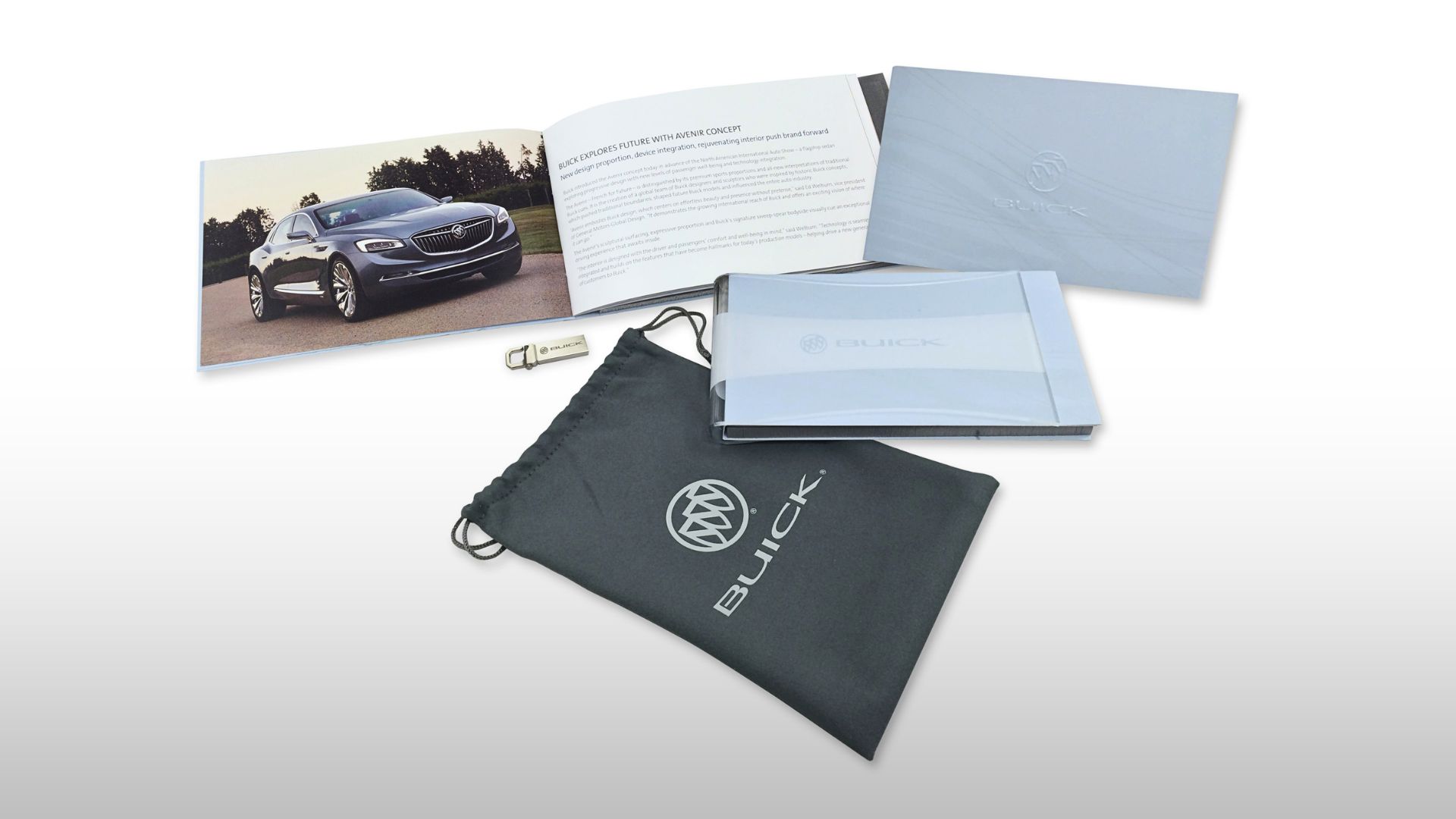 The complete Buick Avenir press kit: booklet, etched lucite sleeve, branded USB drive, and silk-screened felt pouch